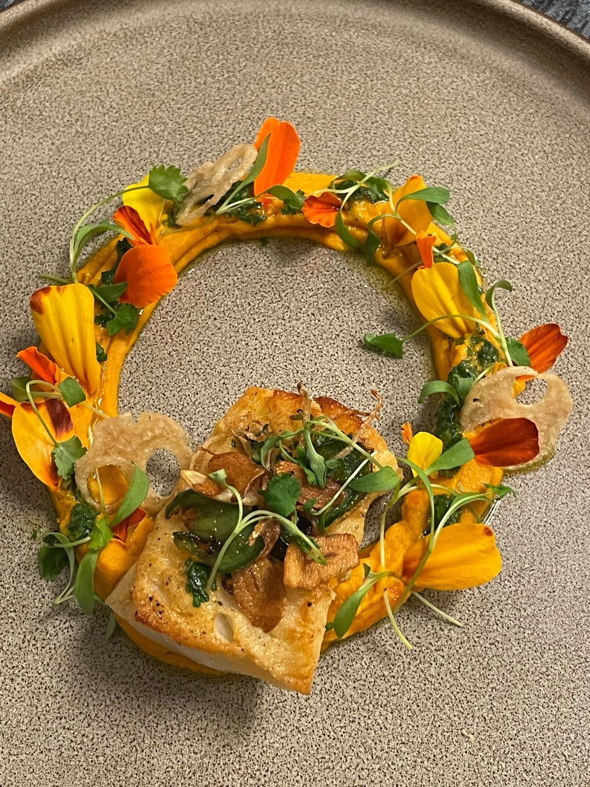 A close up of a plate of food with flowers on it.