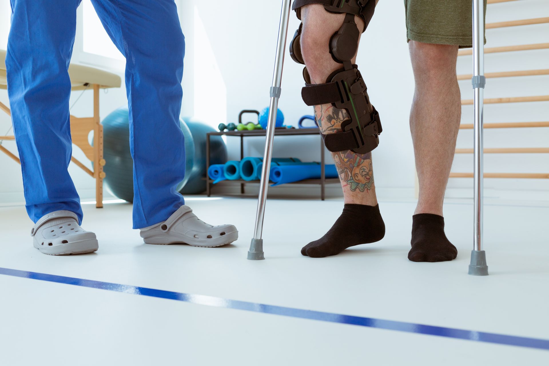 Car accident victim on crutches in physical therapy