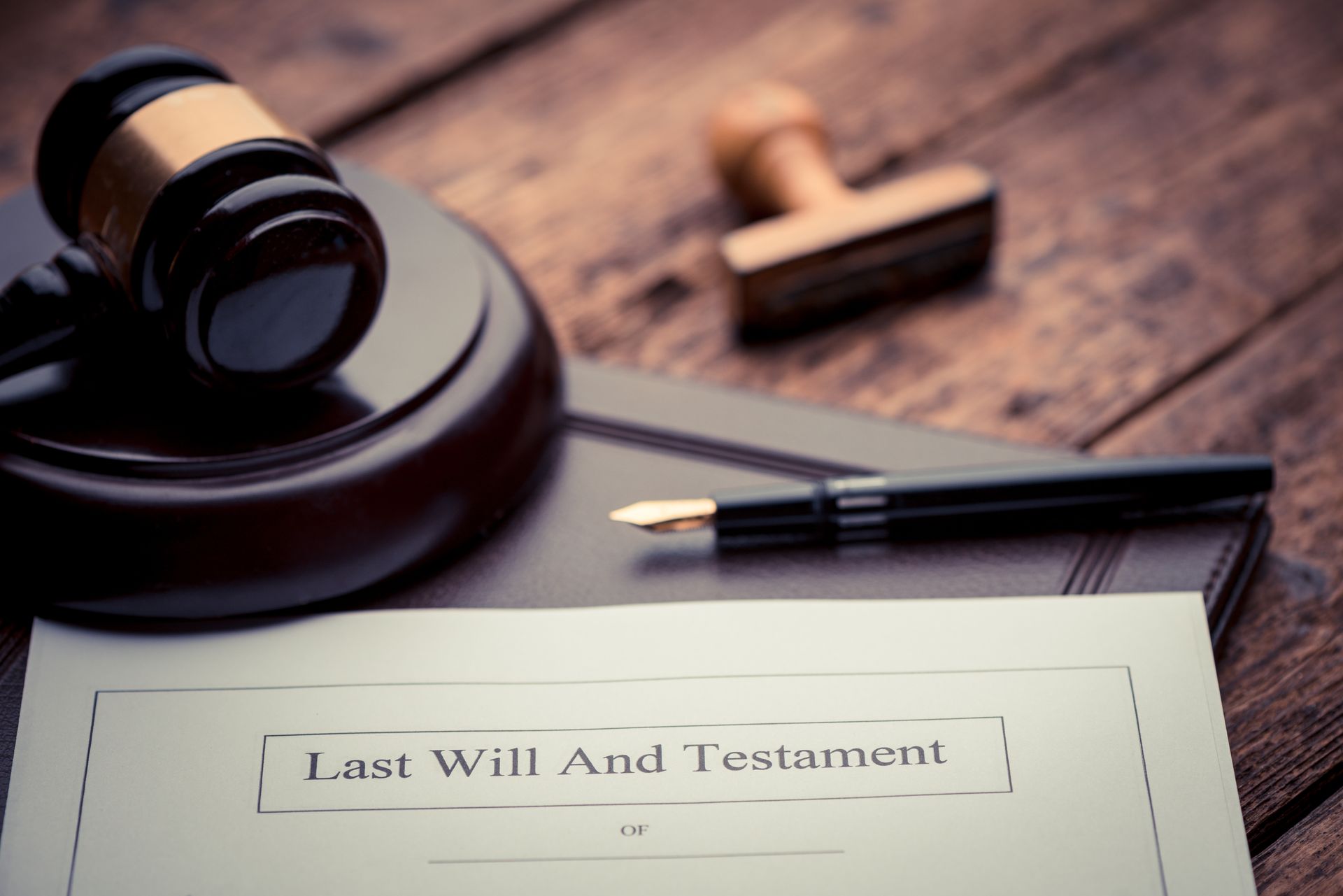 Document with “Last Will And Testament” with a gavel and fountain pen