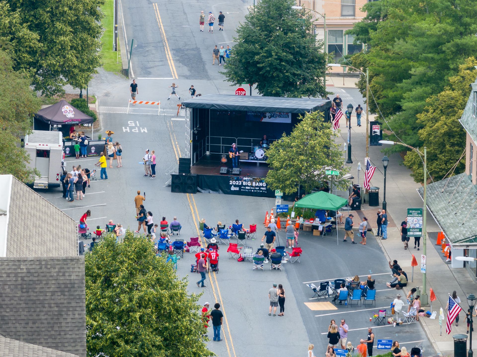 An aerial view of a street with a stage in the middle of it