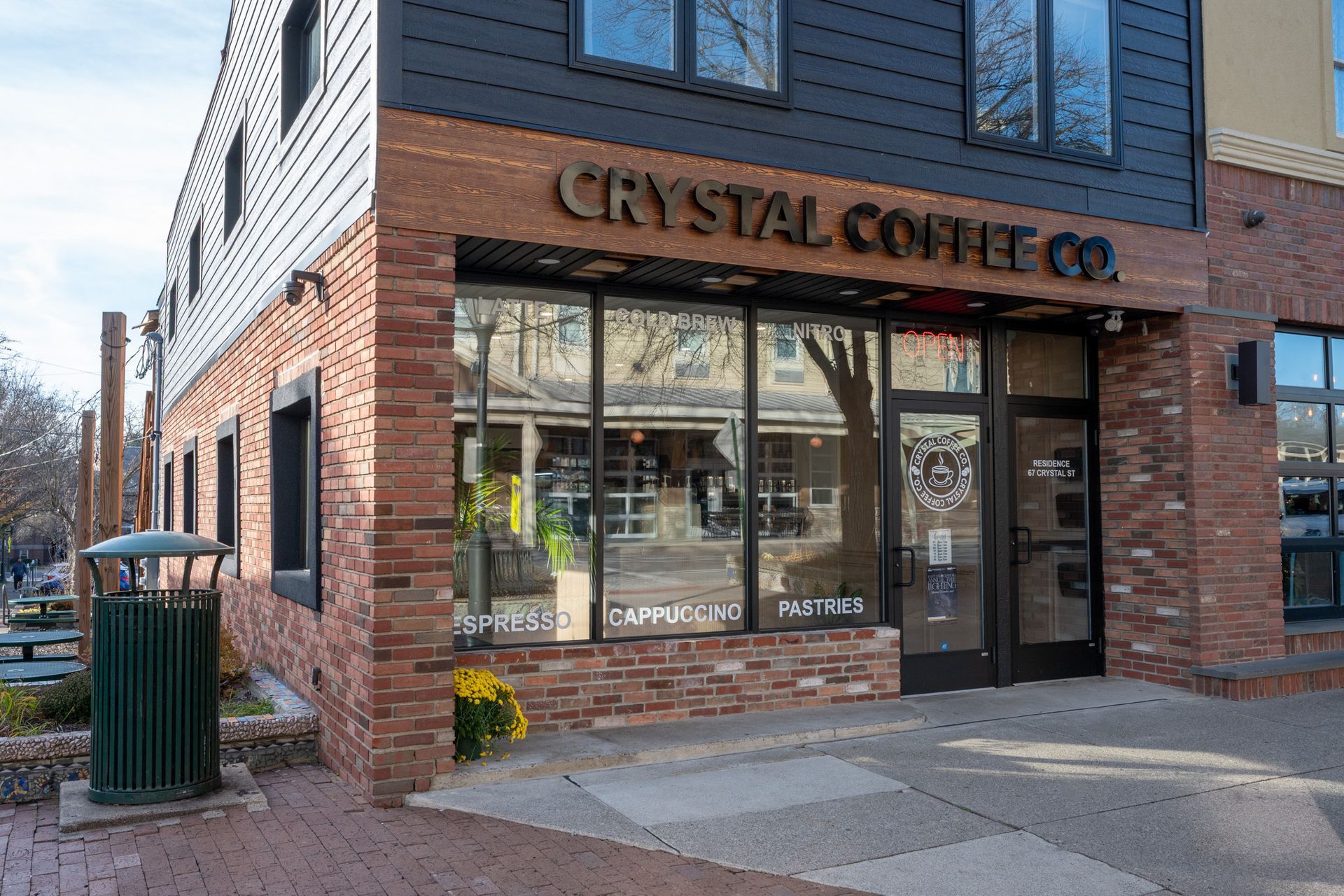 Exterior of Crystal Coffee Co. storefront in a brick building on a sunny street corner