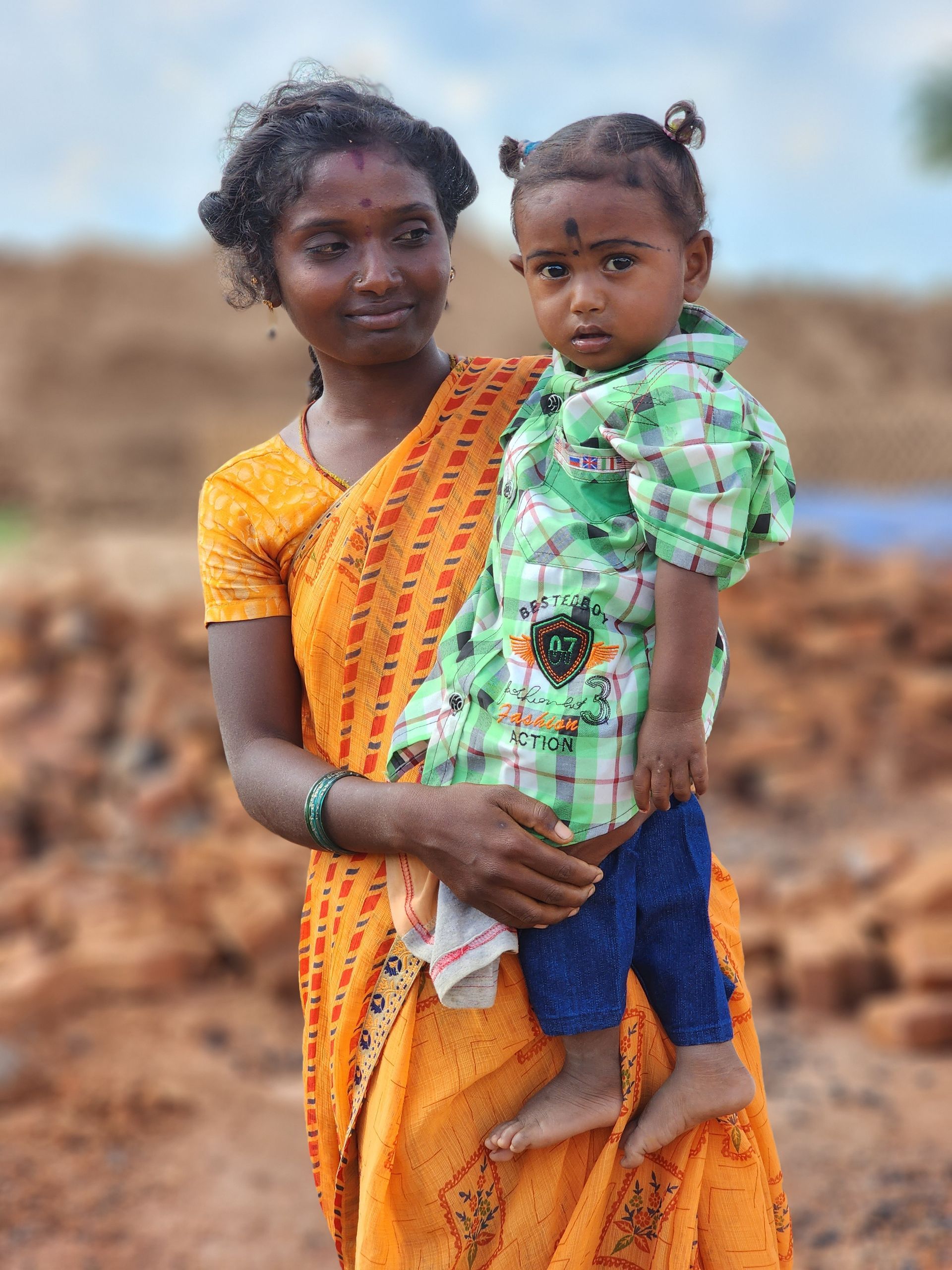 A woman is holding a small child in her arms.