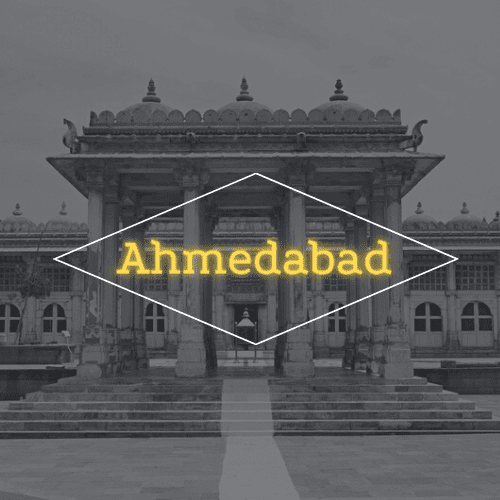 A black and white photo of a building with the word ahmedabad in yellow