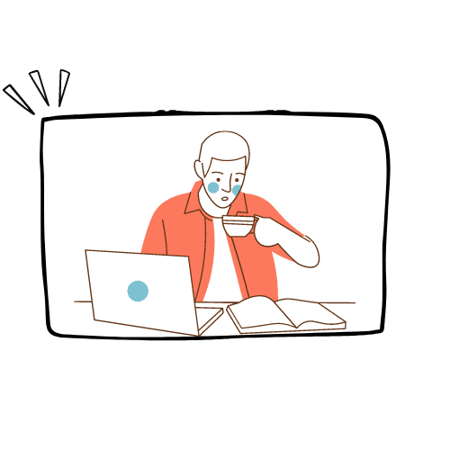 A man is sitting at a desk with a laptop and a cup of coffee.