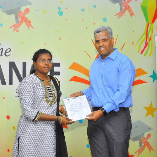 A man in a blue shirt is giving a woman a certificate