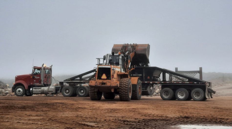 Heavy equipment loading aggregate material onto a trailer at Stensland Gravel in Larchwood, Iowa