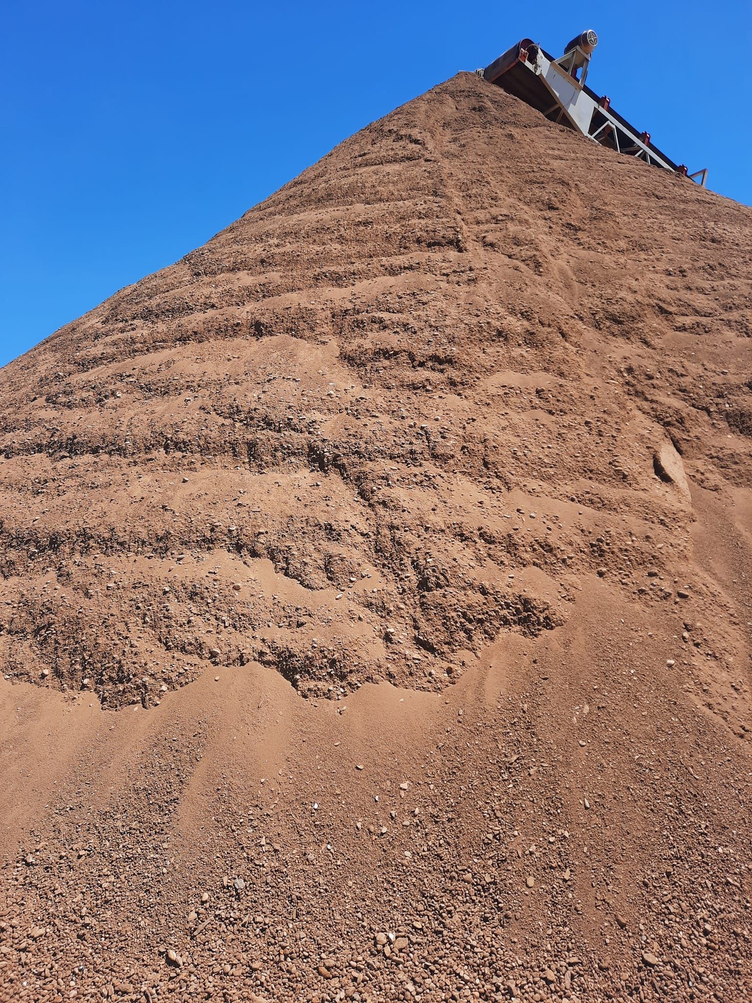 Crushed gravel and aggregate material stockpile at Stensland Gravel in Larchwood, Iowa