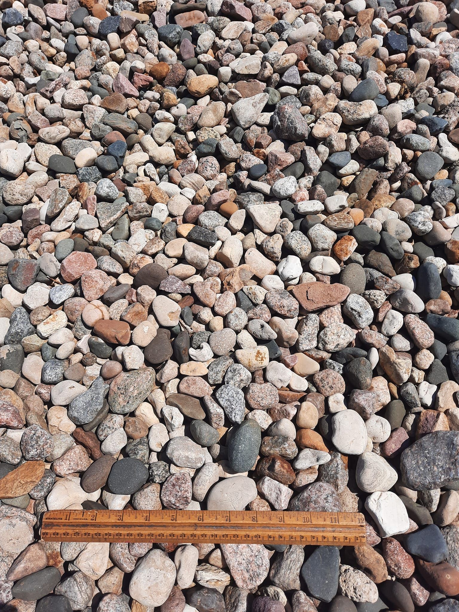 Mixed river rock aggregate for landscaping and drainage projects in Larchwood, Iowa