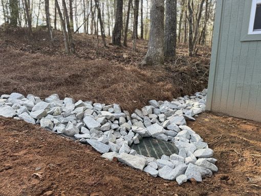 Drainage rock installation around a catch basin for erosion control in Larchwood, Iowa