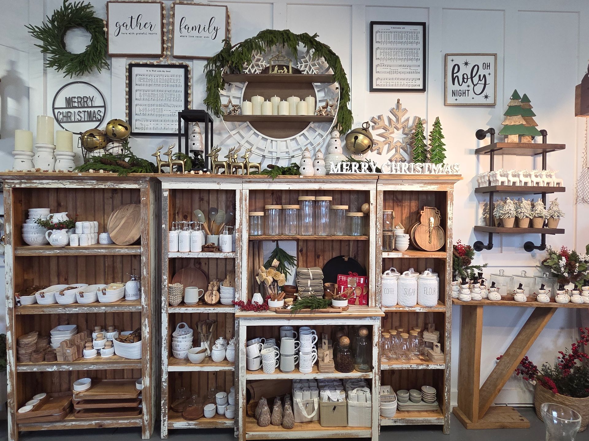 A shelf full of wicker baskets and a sign that says ' handmade ' on it