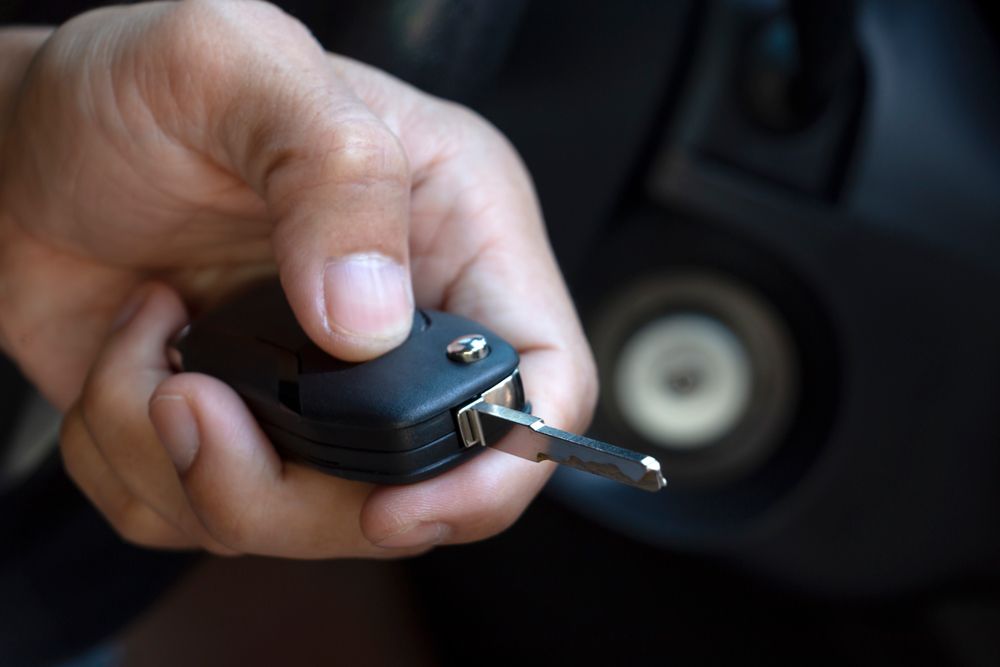 Human Hand Holding a Keyless Entry Device — Cairns, QLD — Guardian Lock Services