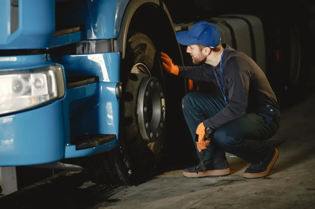 Mobile mechanic shaking hands with a truck driver