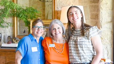 three women of various ages smiling for the camera