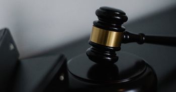 A close up of a judge 's gavel on a table.