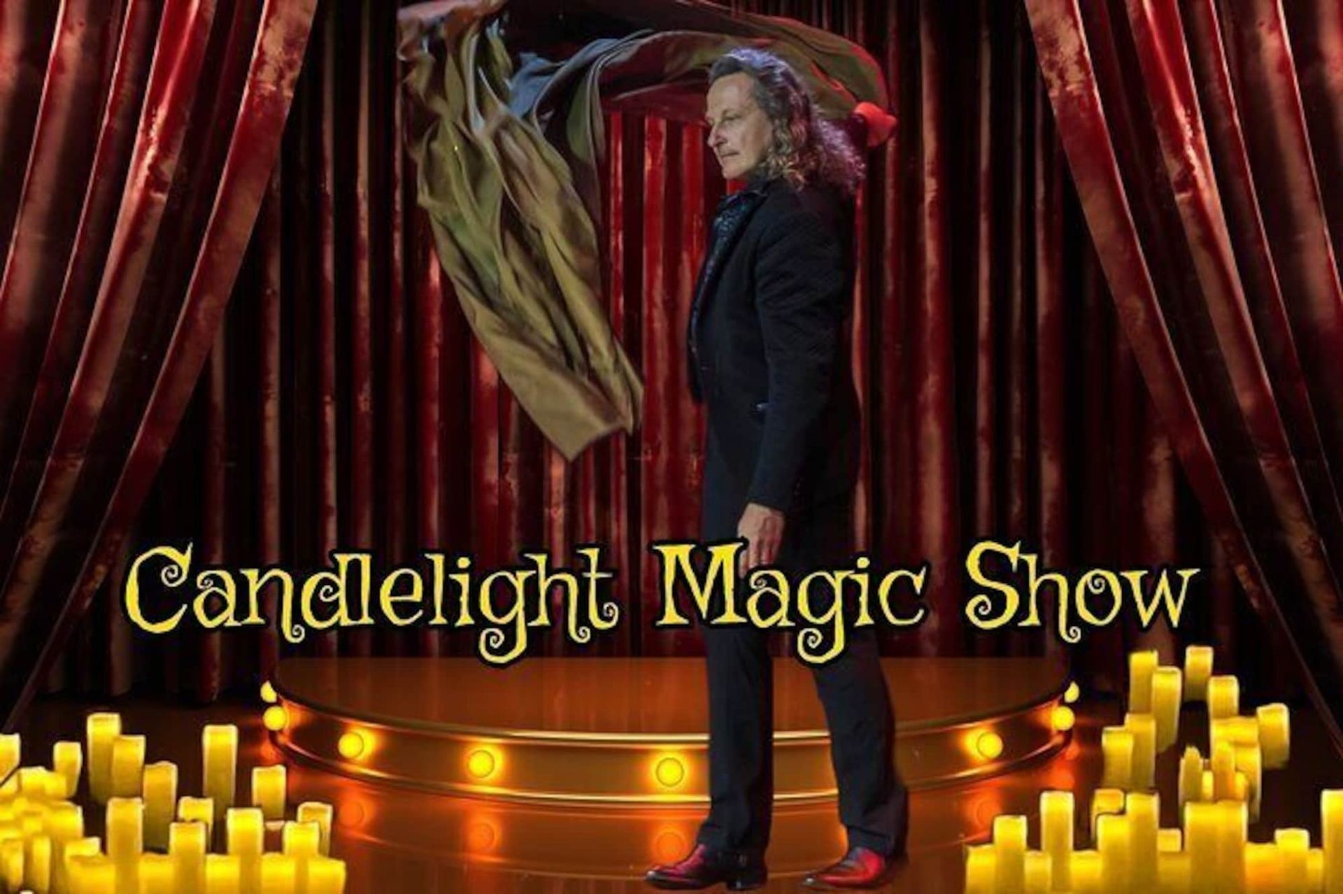 a man in a suit is standing on a stage with candles in the background .