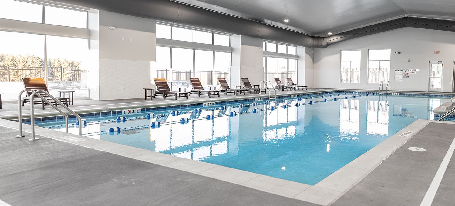 The Pines - swimming pool with lounge chairs
