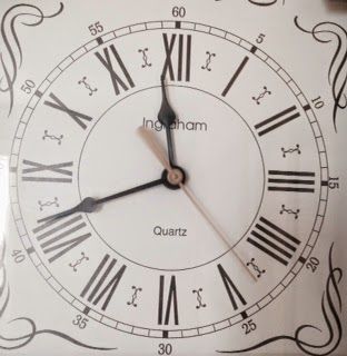 A quartz clock with roman numerals on it