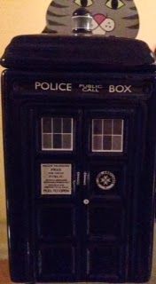 A police box with a cat on top of it