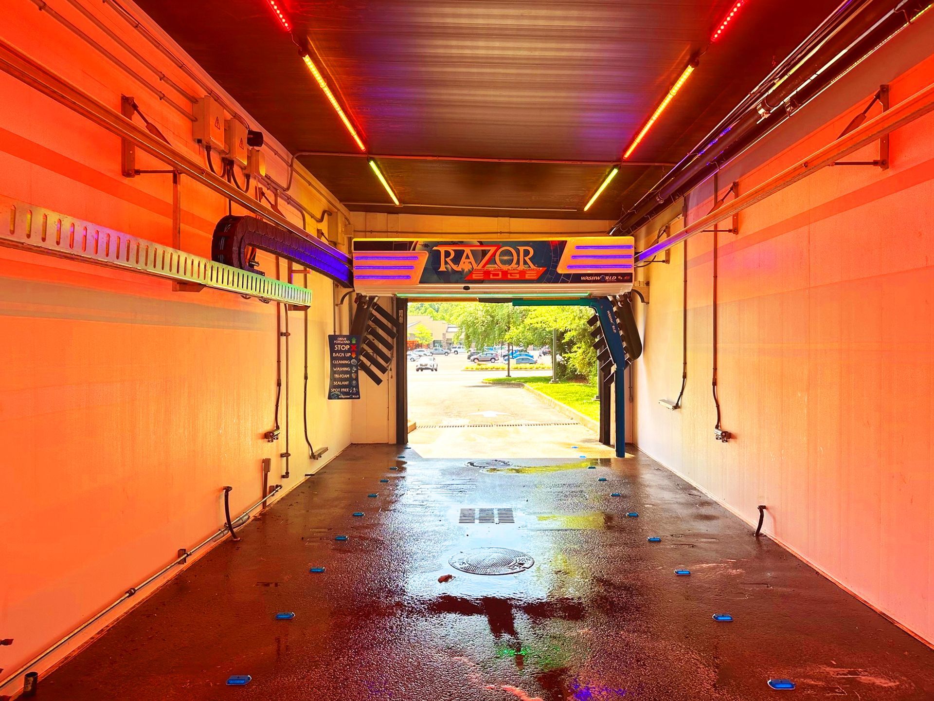 A car wash kiosk with a touch screen displaying wash options.