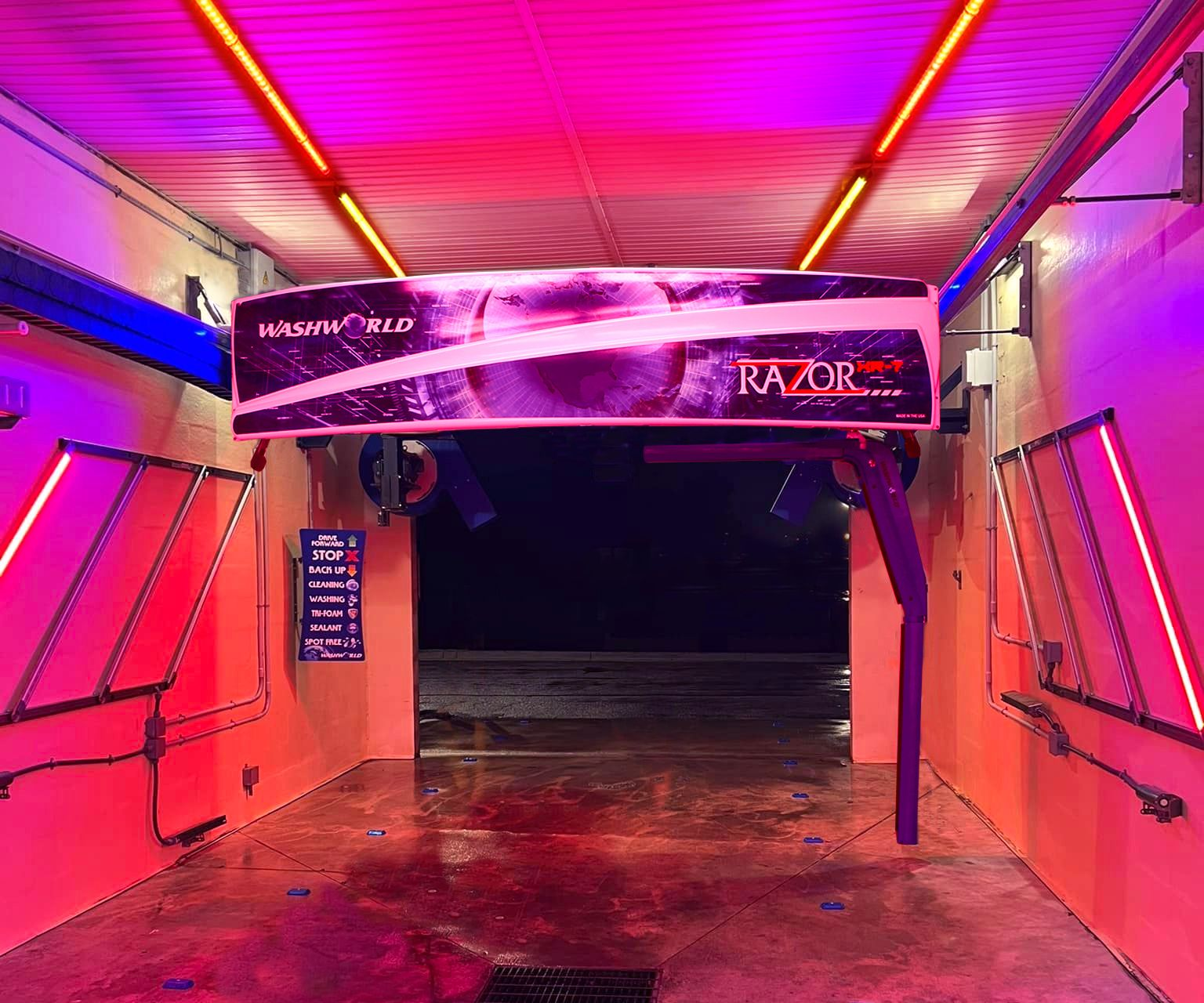 A car wash kiosk with a touch screen displaying wash options.