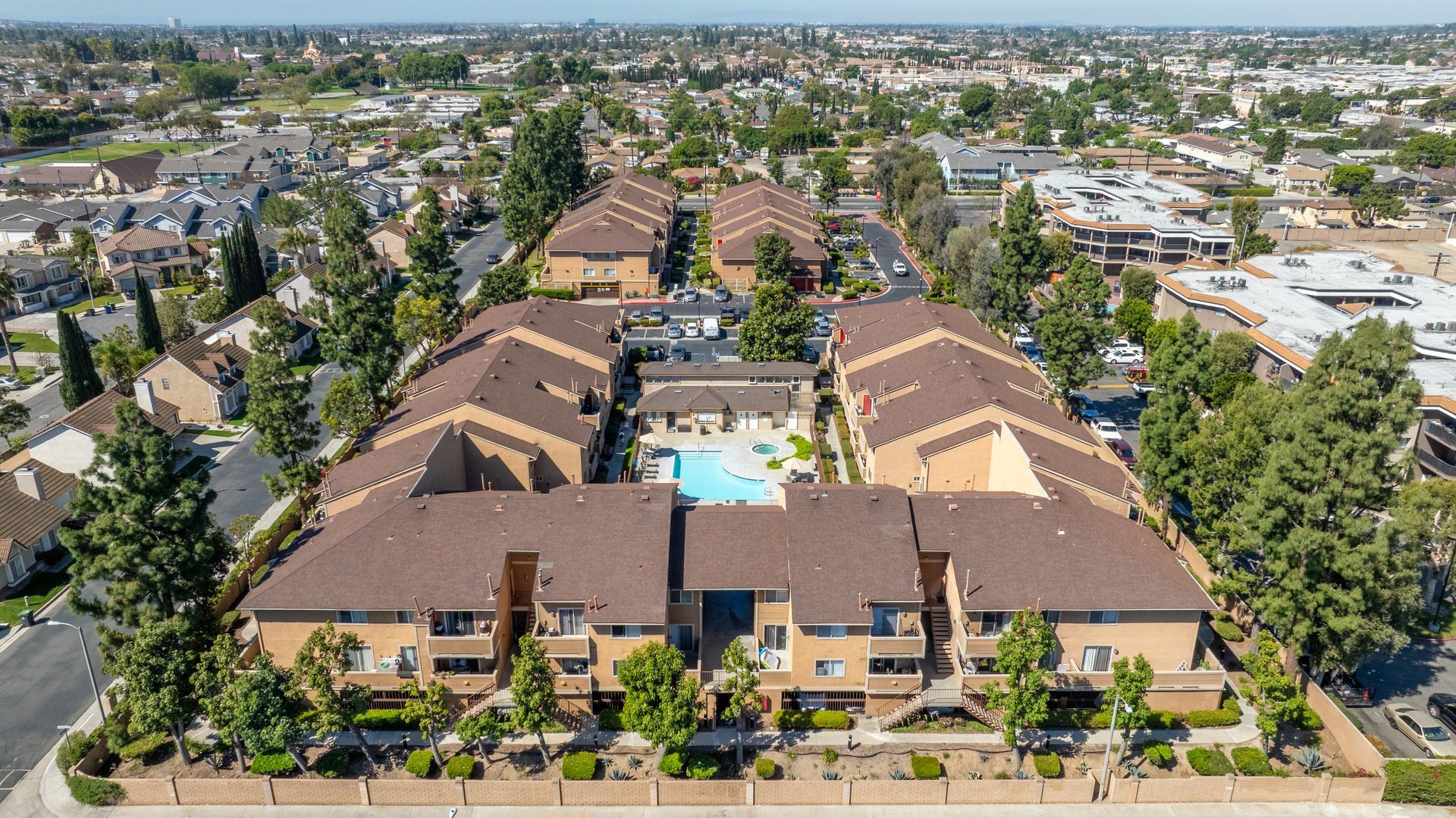 Overhead view of apartment buildings with central swimming pool