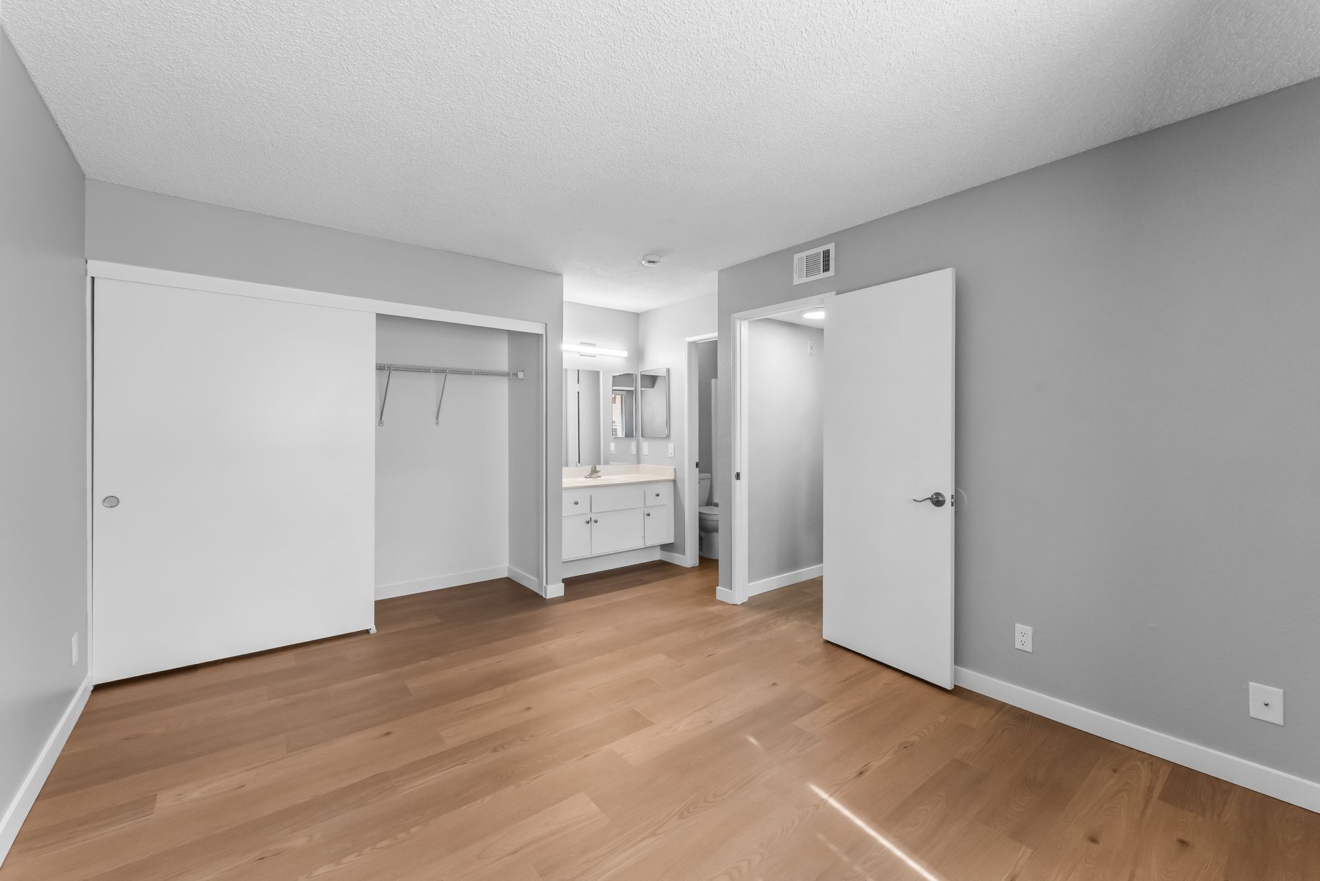 bedroom with sliding closet and vanity mirror
