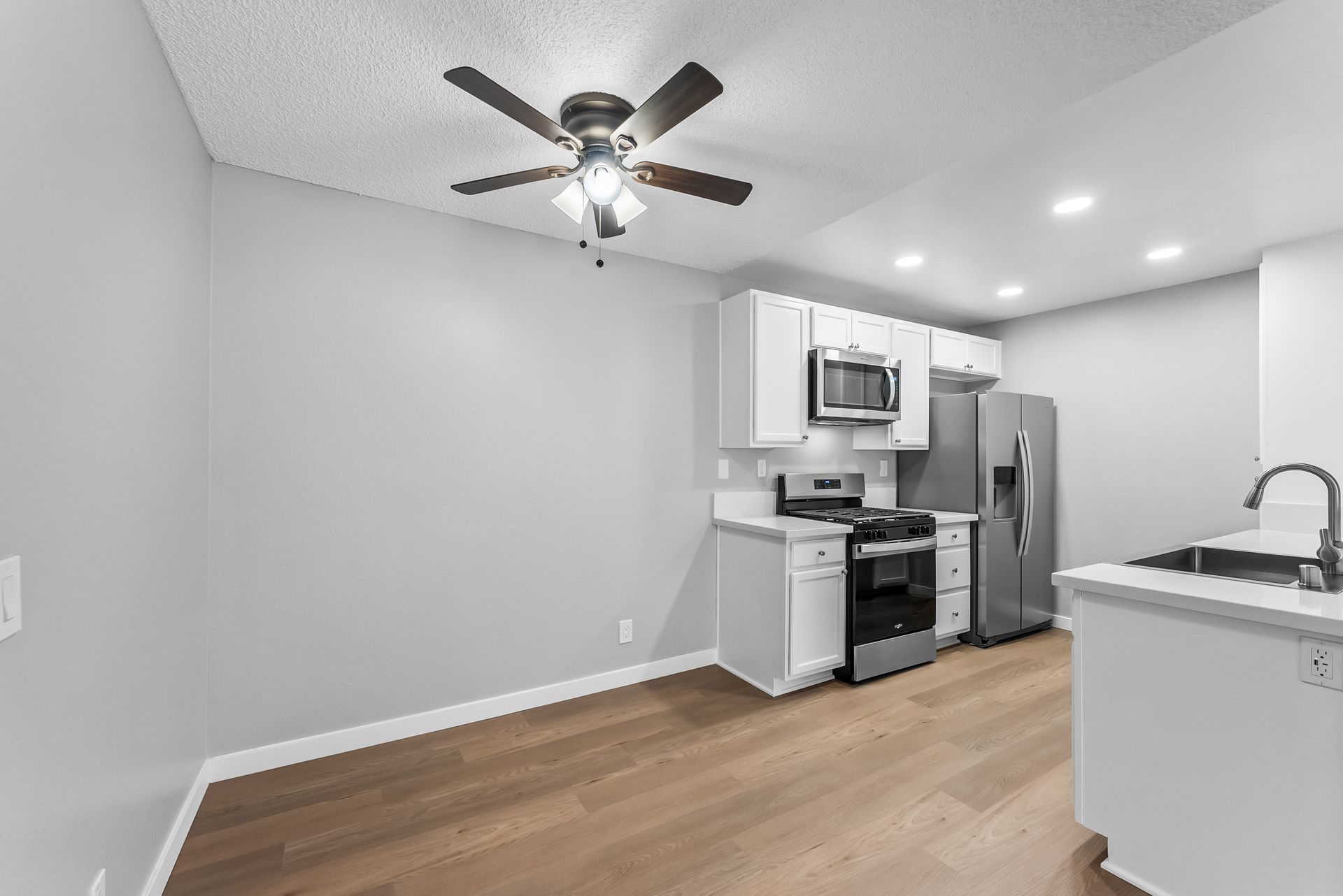 Dining room with ceiling fan and view of the kitchen