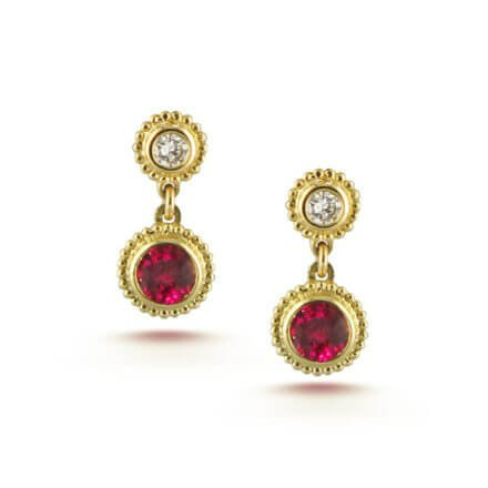 A pair of ruby and diamond earrings in yellow gold