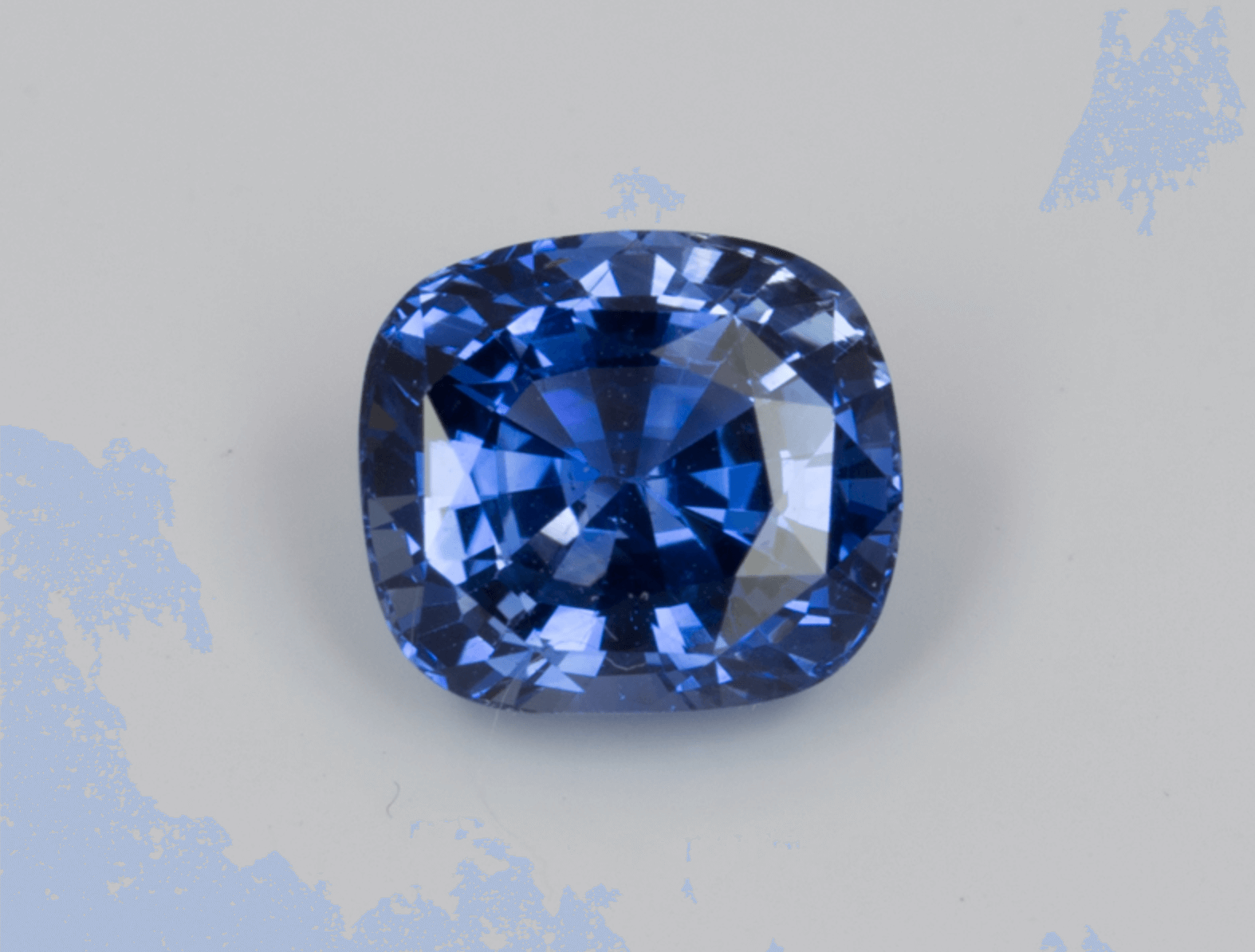 A blue sapphire is sitting on a white surface