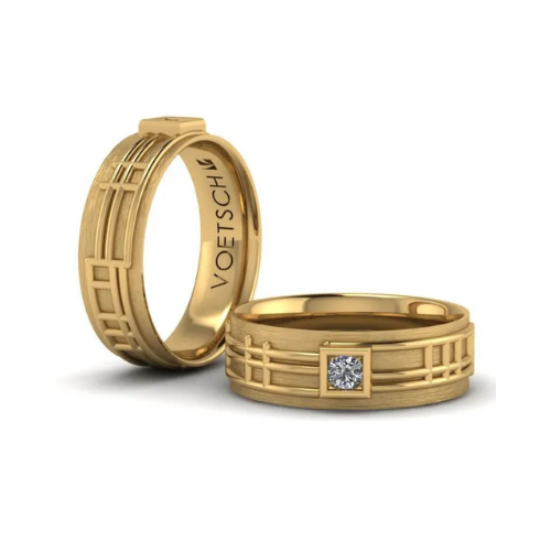 A gold ring with the word voetsch on it