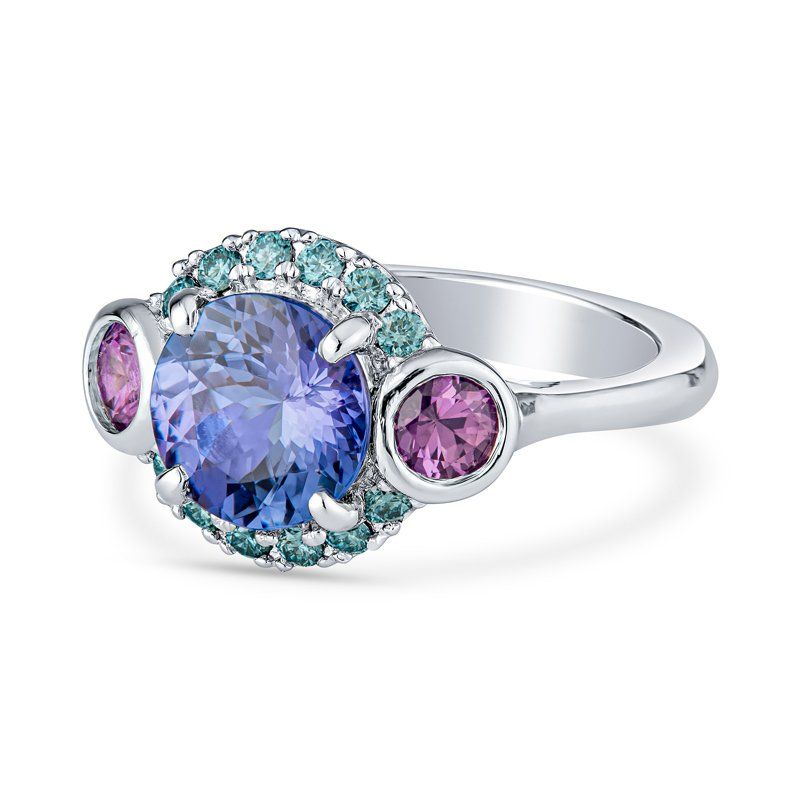 A ring with purple and blue stones on a white background