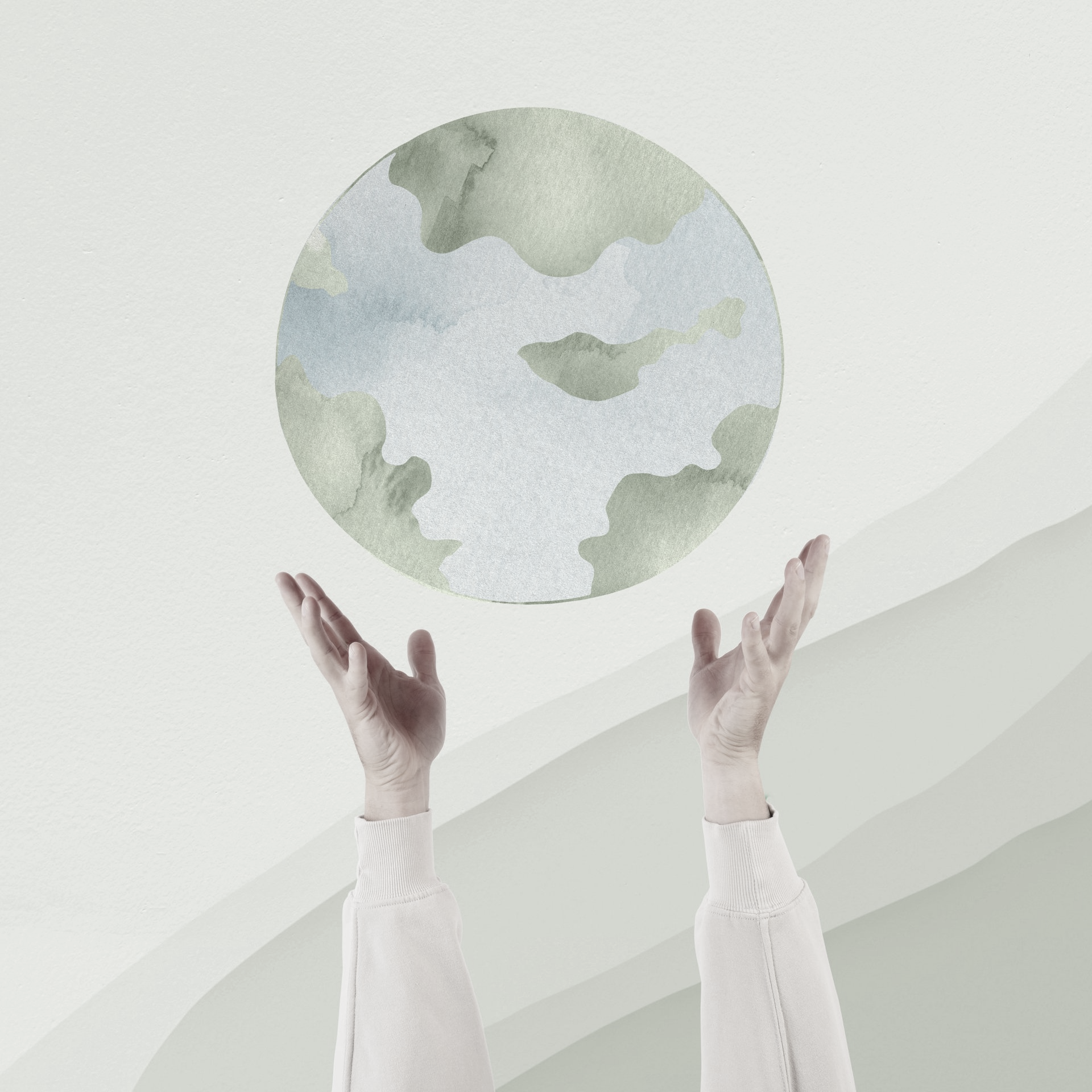 A person is holding a globe in their hands
