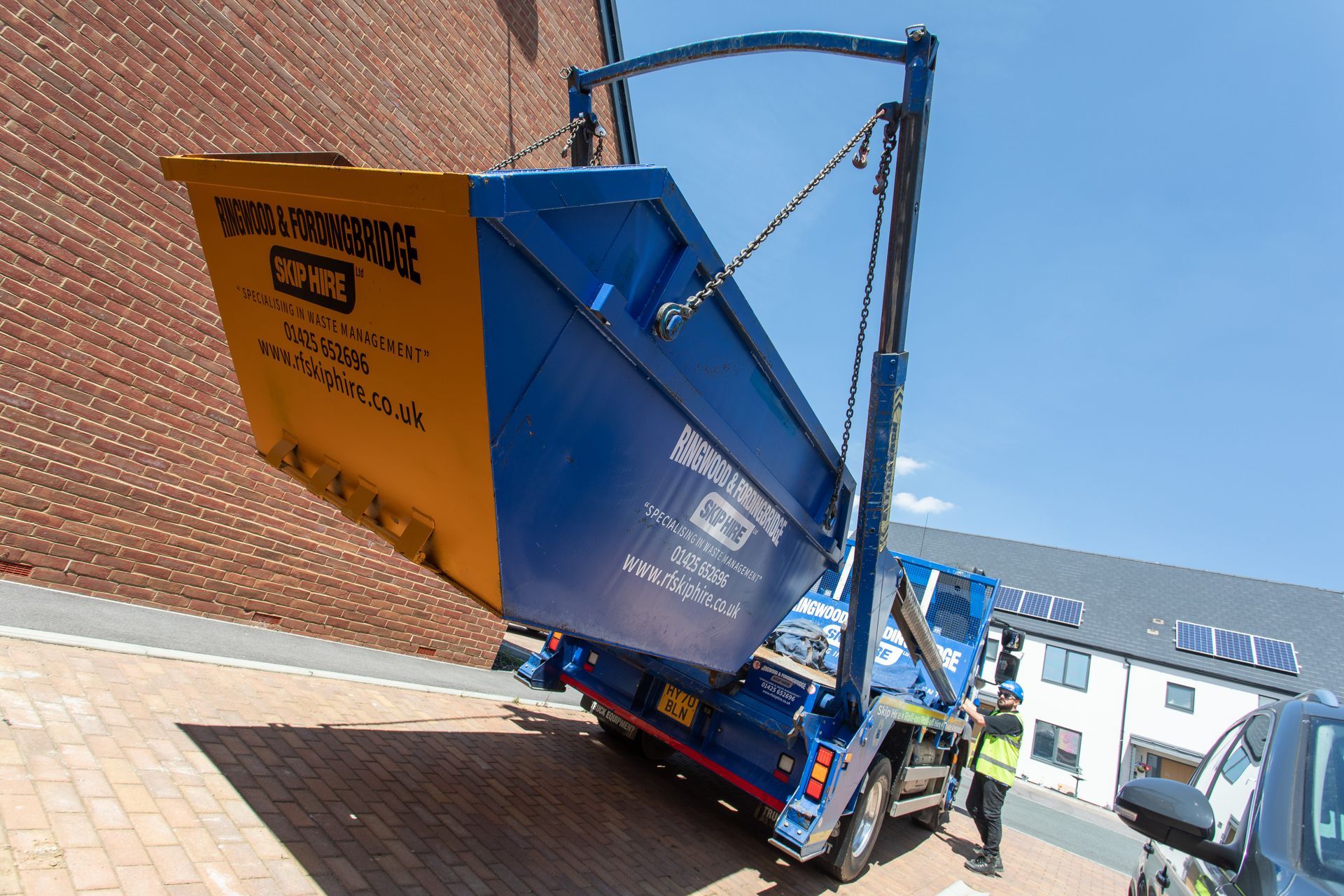 rf recycling unloading a skip onto a driveway 