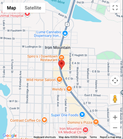 Google Maps street map with nearby businesses marked by red pins in downtown Iron Mountain, MI