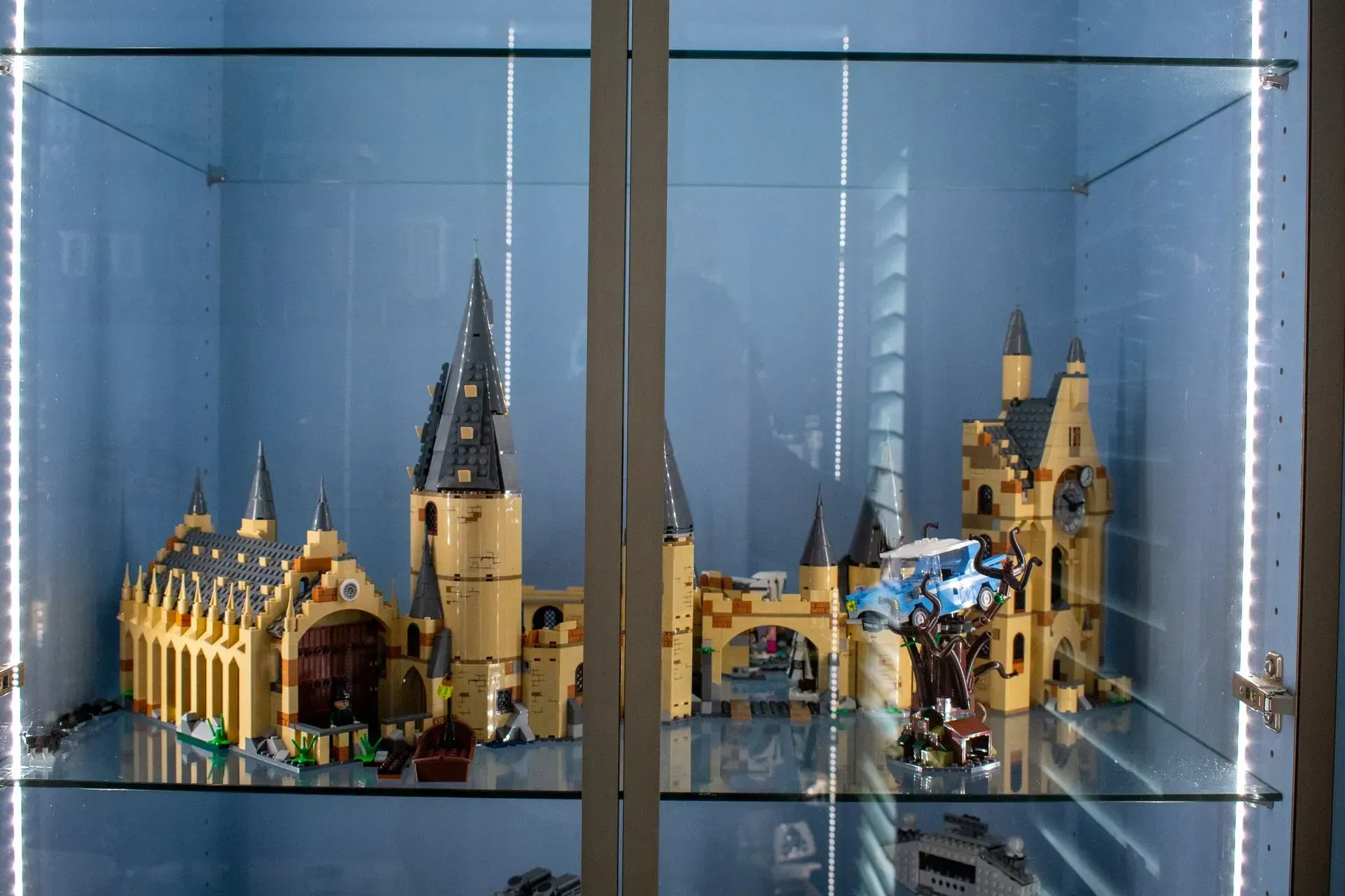 A display case filled with lots of lego castles and buildings.