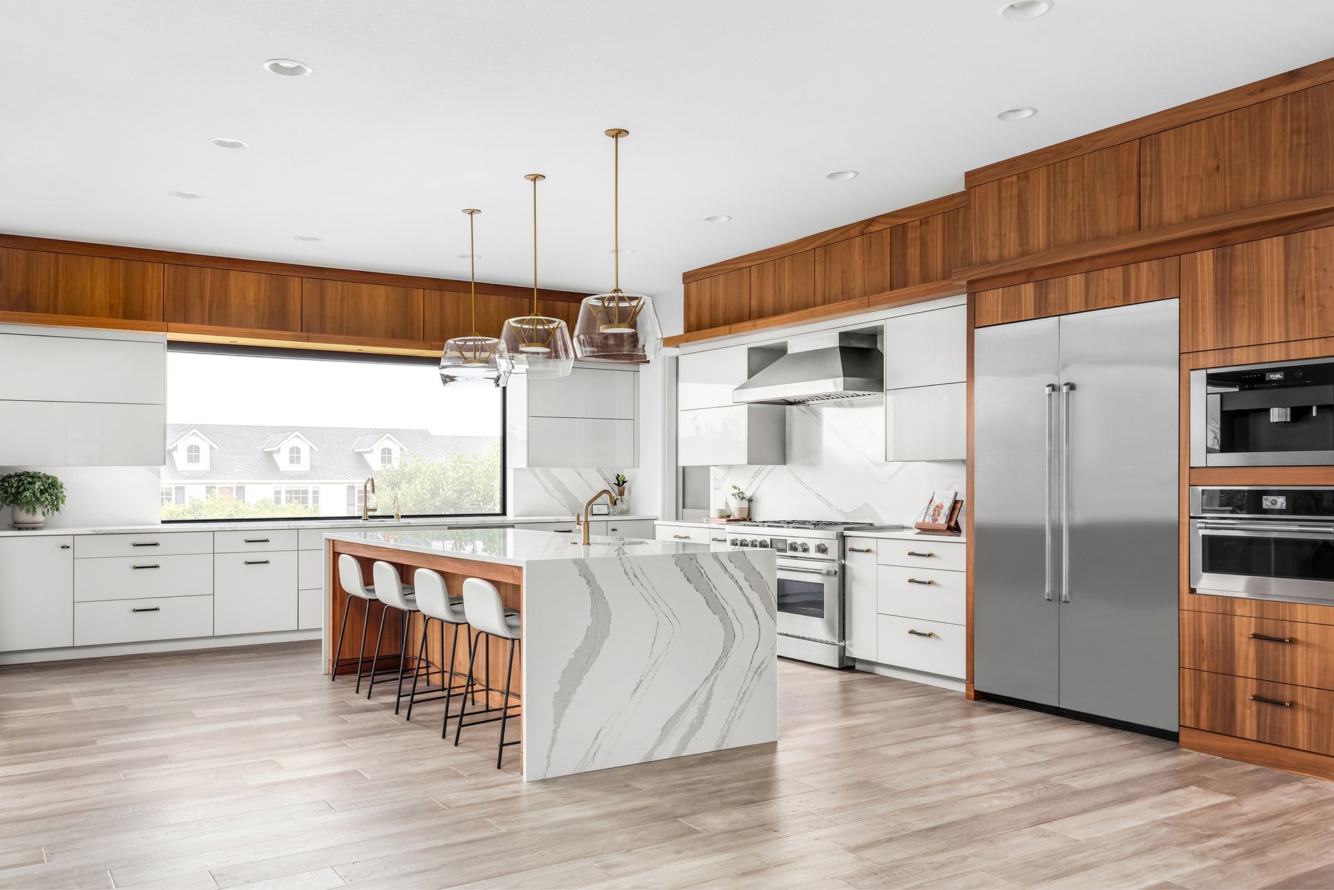 A large kitchen with stainless steel appliances and wooden cabinets.