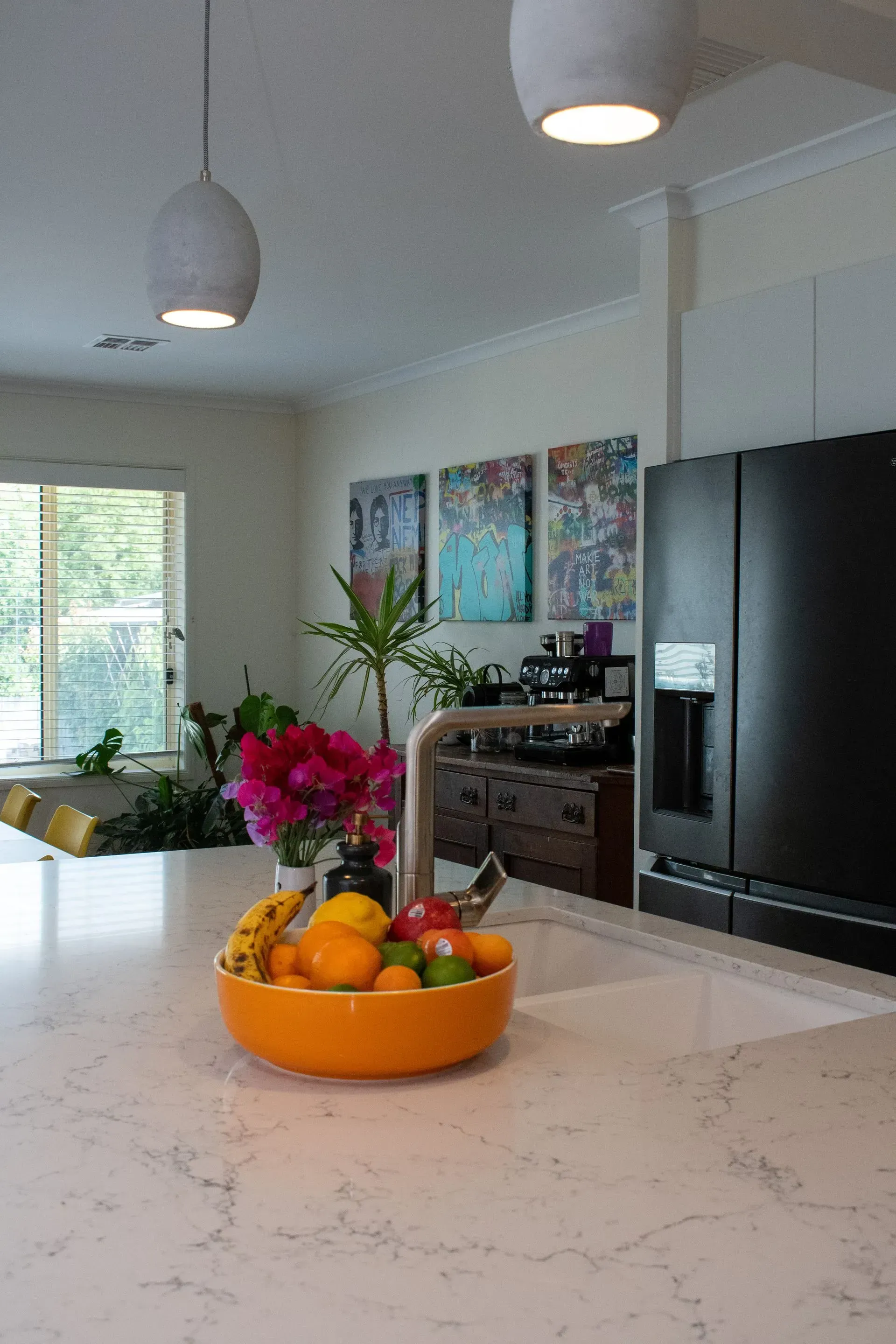 A kitchen with gray cabinets and white counter tops
