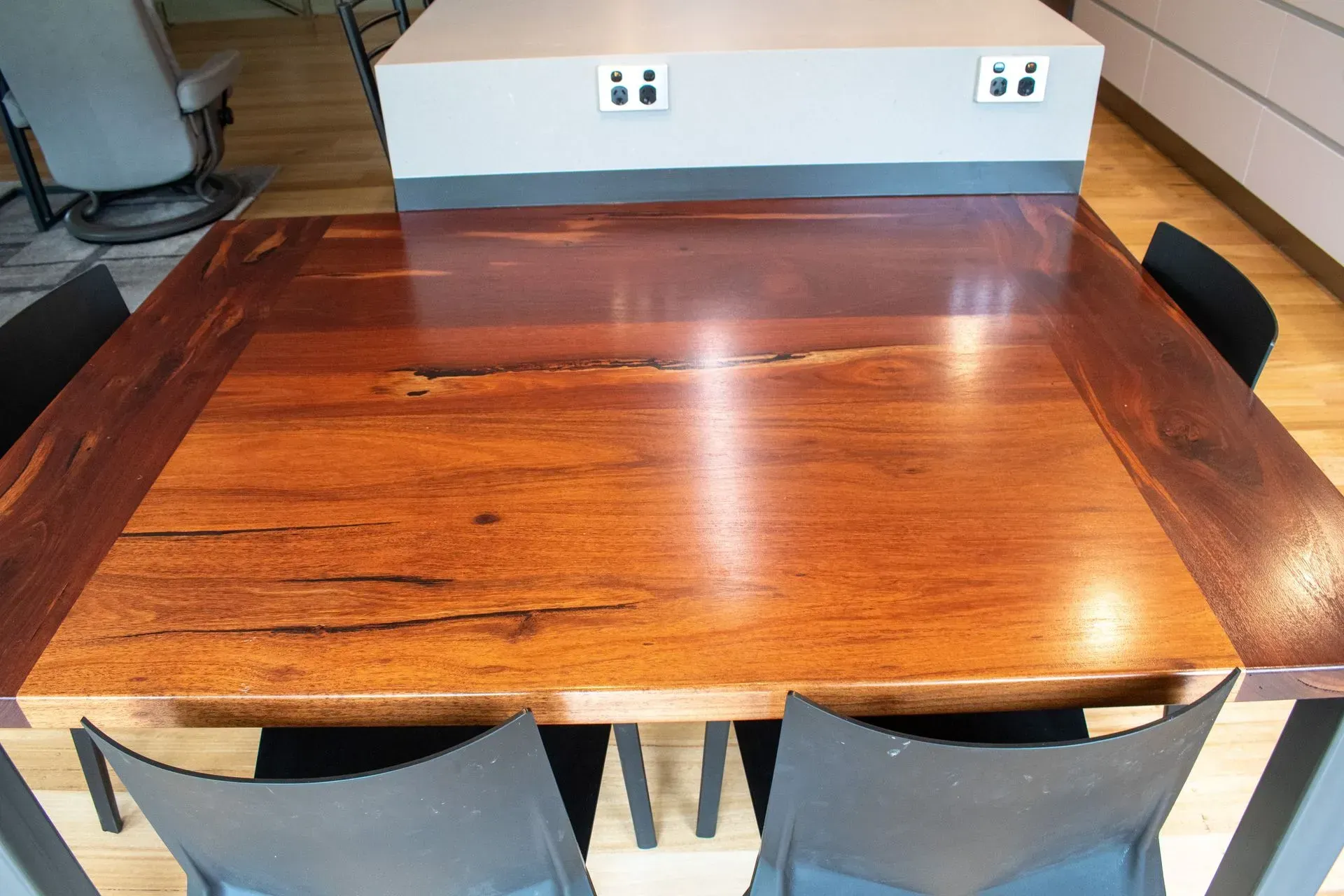 A wooden table with four chairs in a kitchen