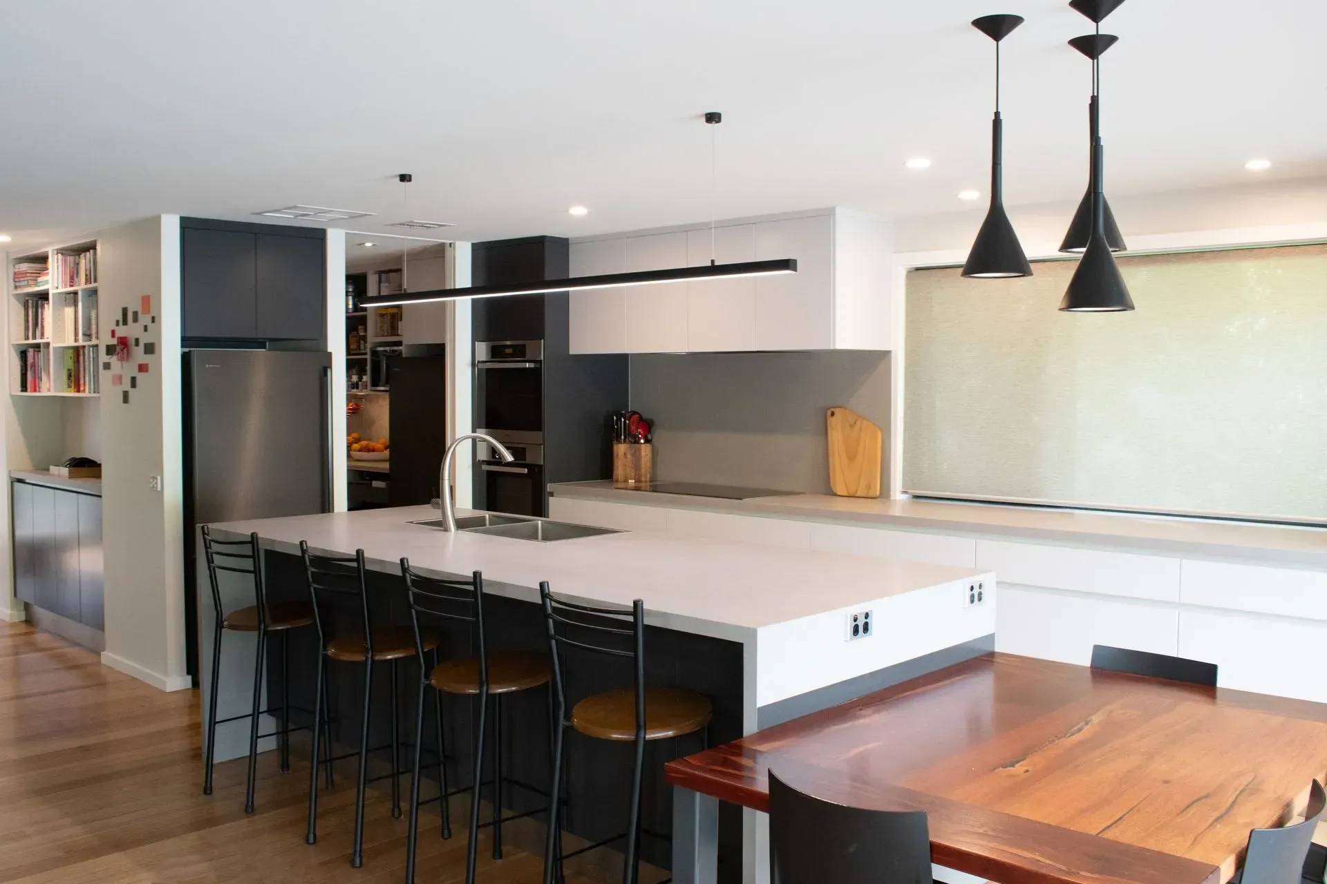 A kitchen with a table and chairs and a large island.