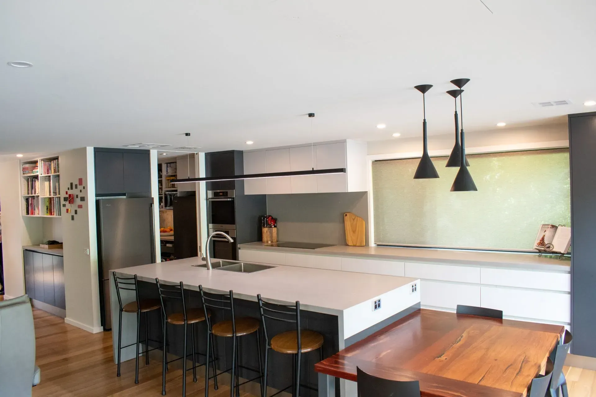 A kitchen with a large island and a dining table