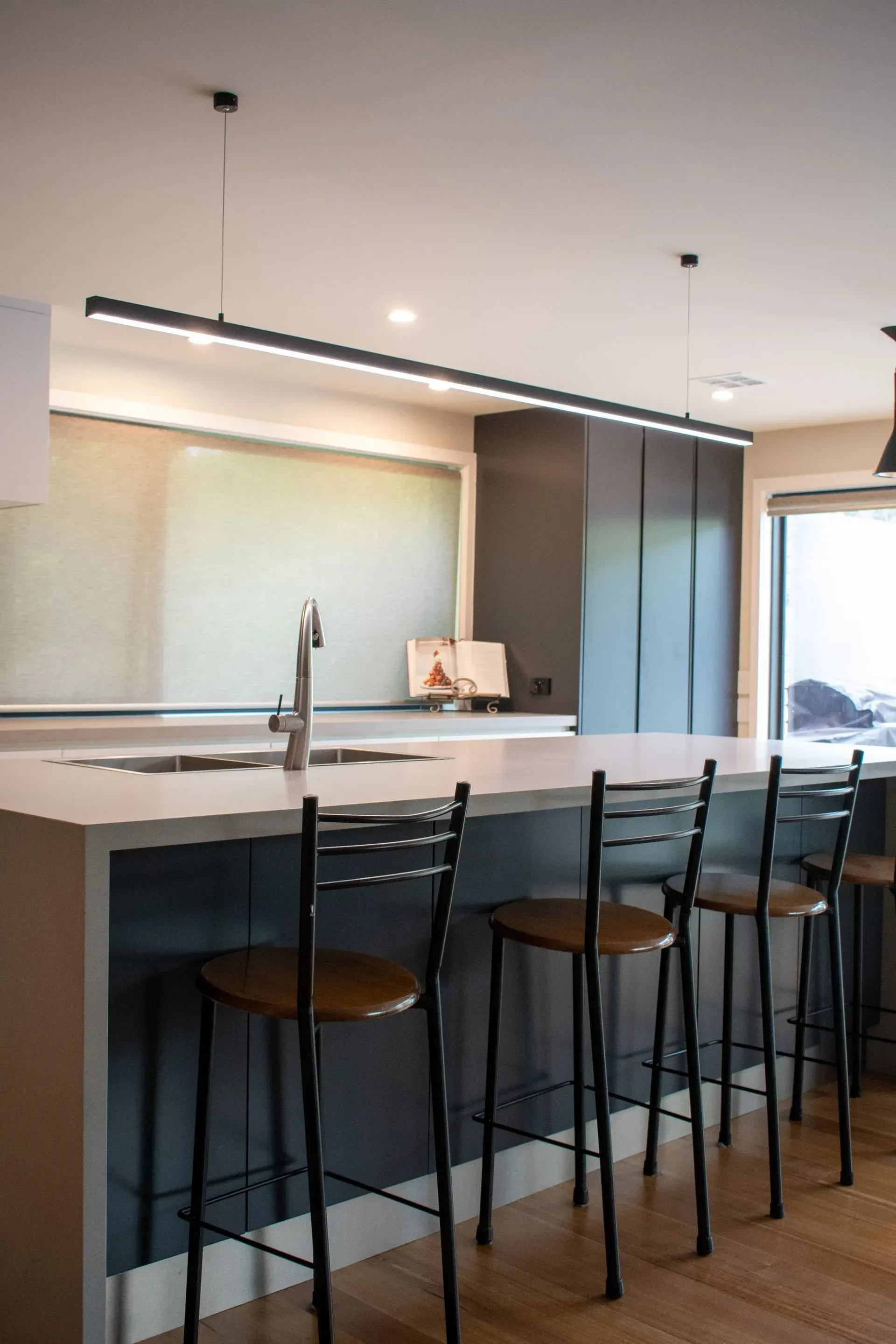 A large kitchen with stainless steel appliances and wooden cabinets.