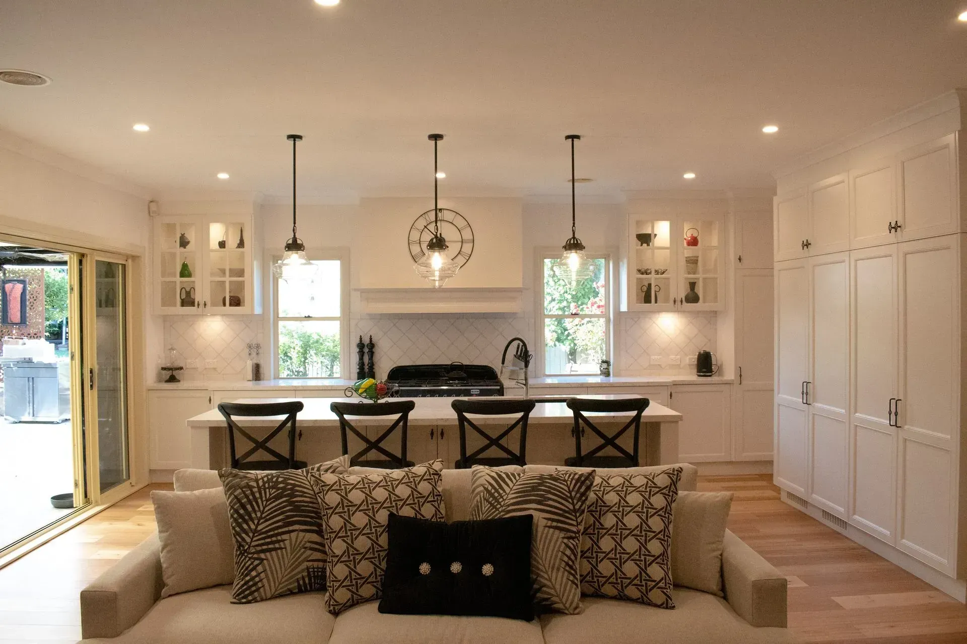 A living room with a couch and a kitchen in the background