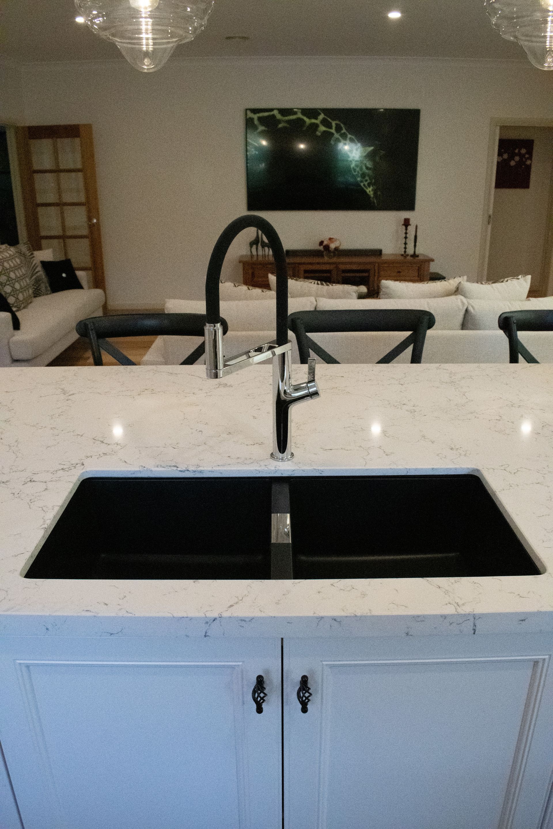 A kitchen with a black sink and a faucet