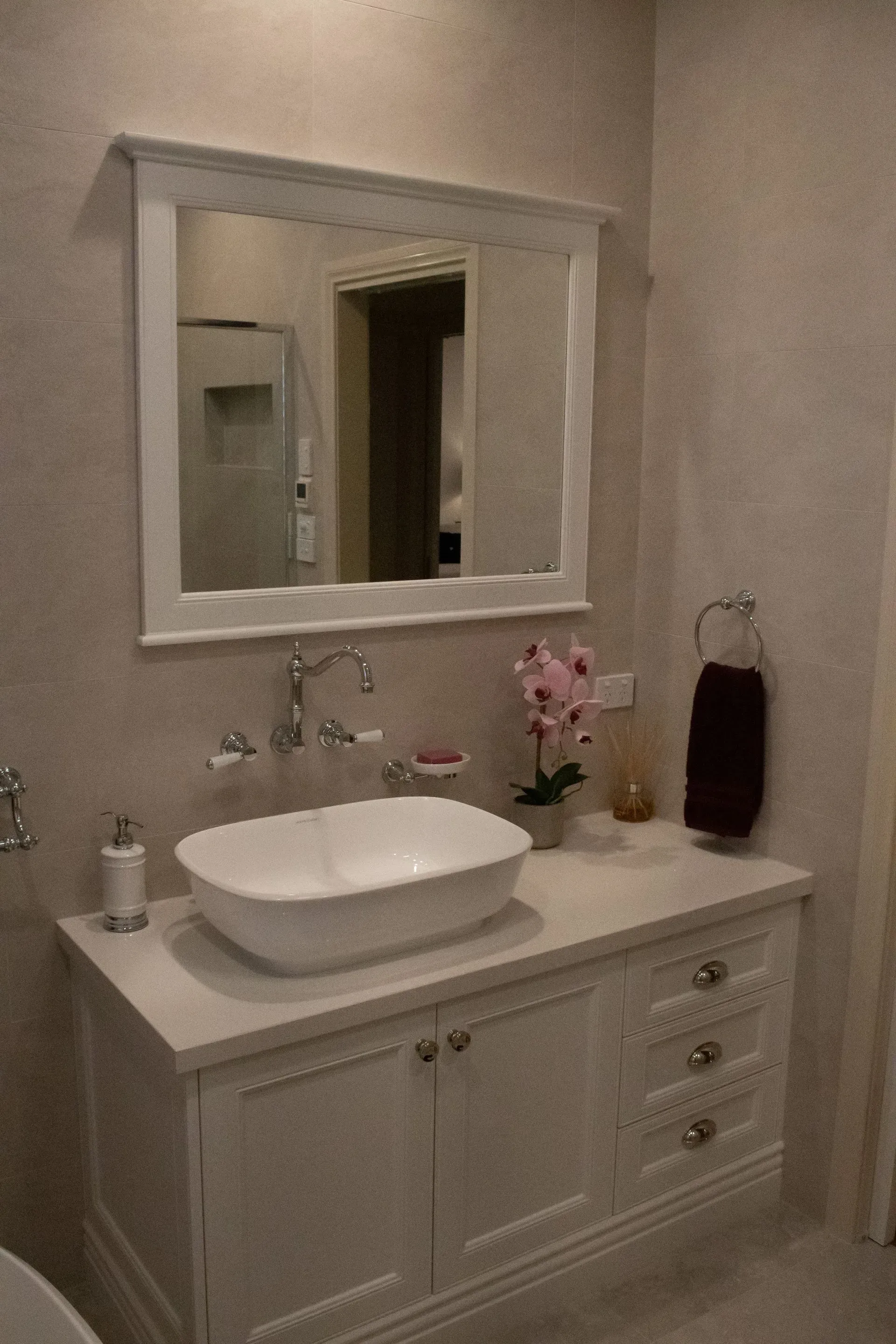 A bathroom with a sink , mirror , and cabinets.