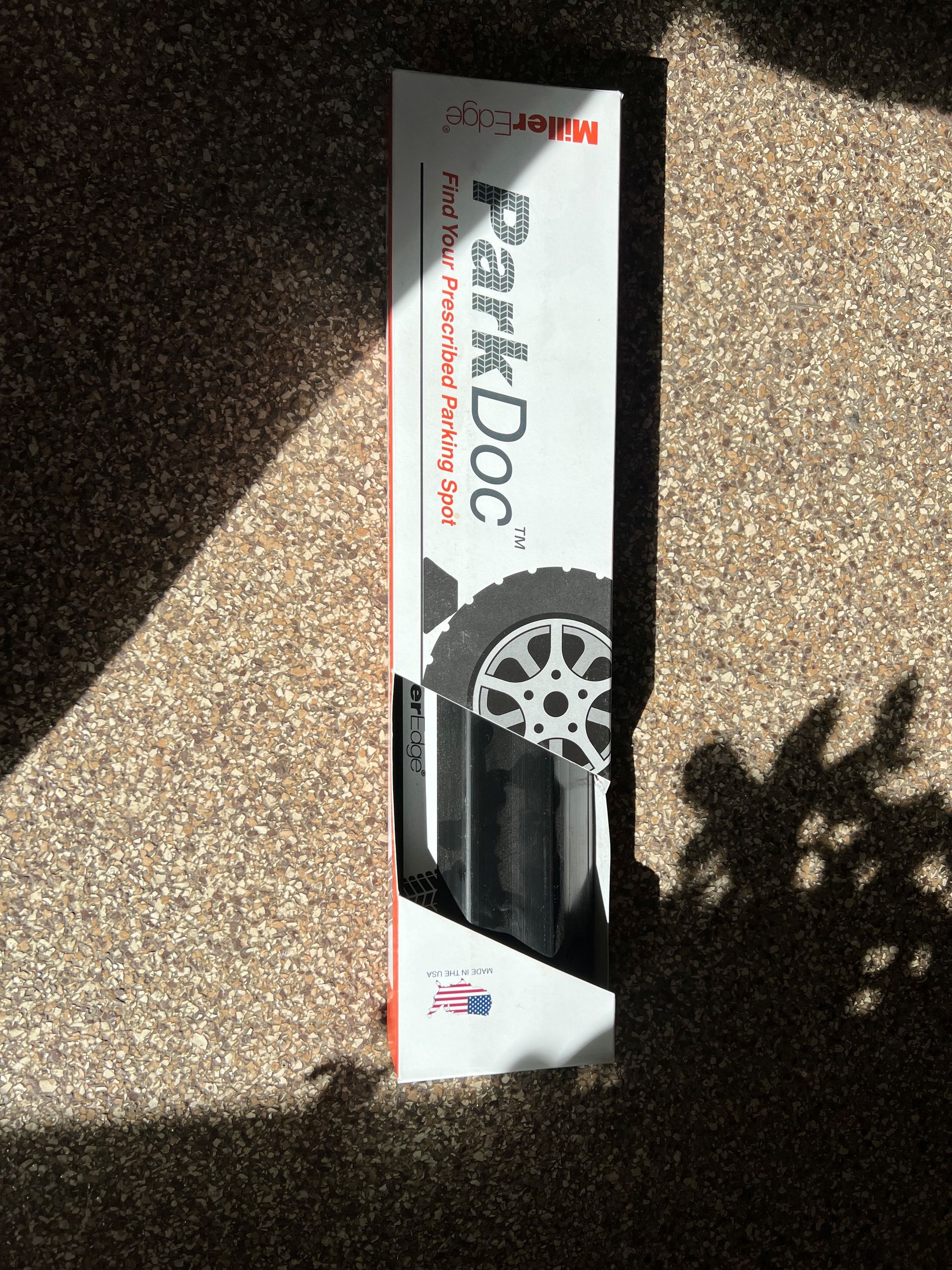 Park Tool bicycle repair stand box on a carpeted floor in sunlight