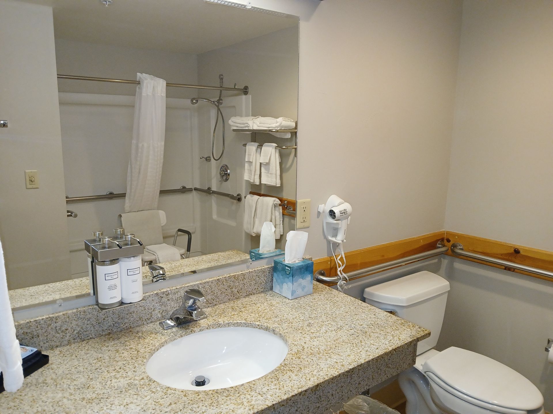 A bathroom with a sink , toilet and mirror