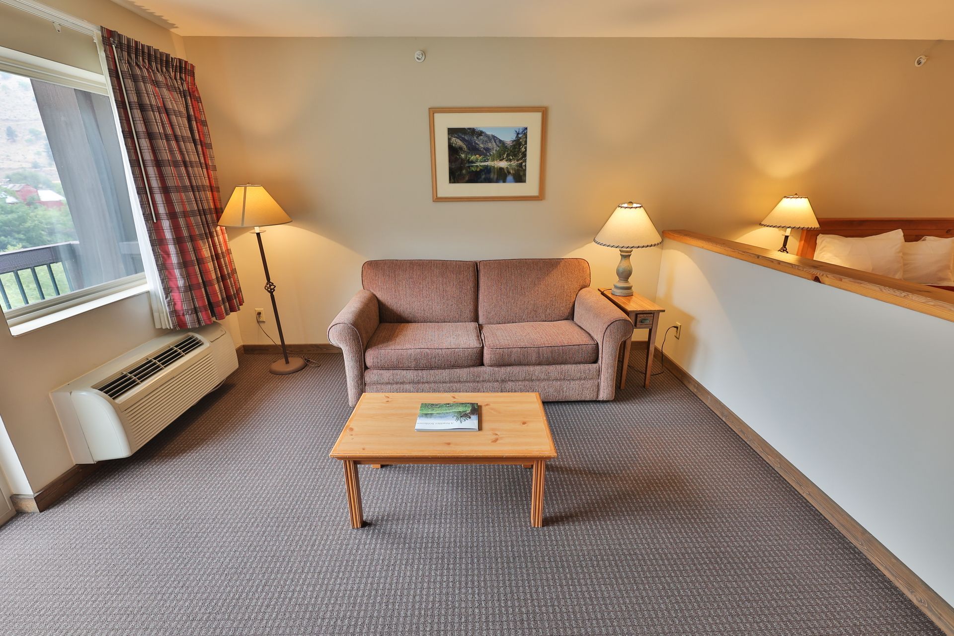 A hotel room with a couch and a coffee table