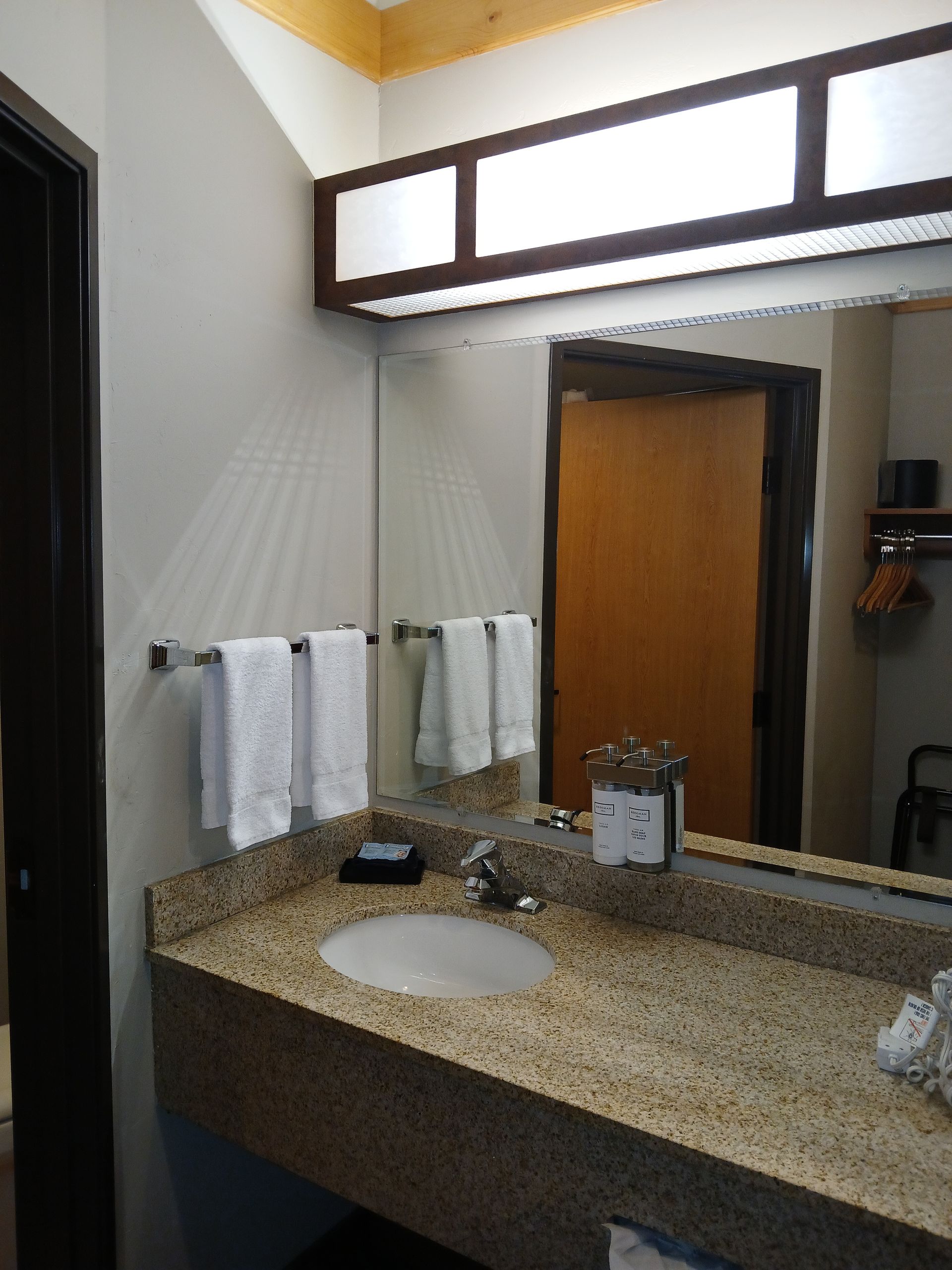 A bathroom with a sink and a large mirror