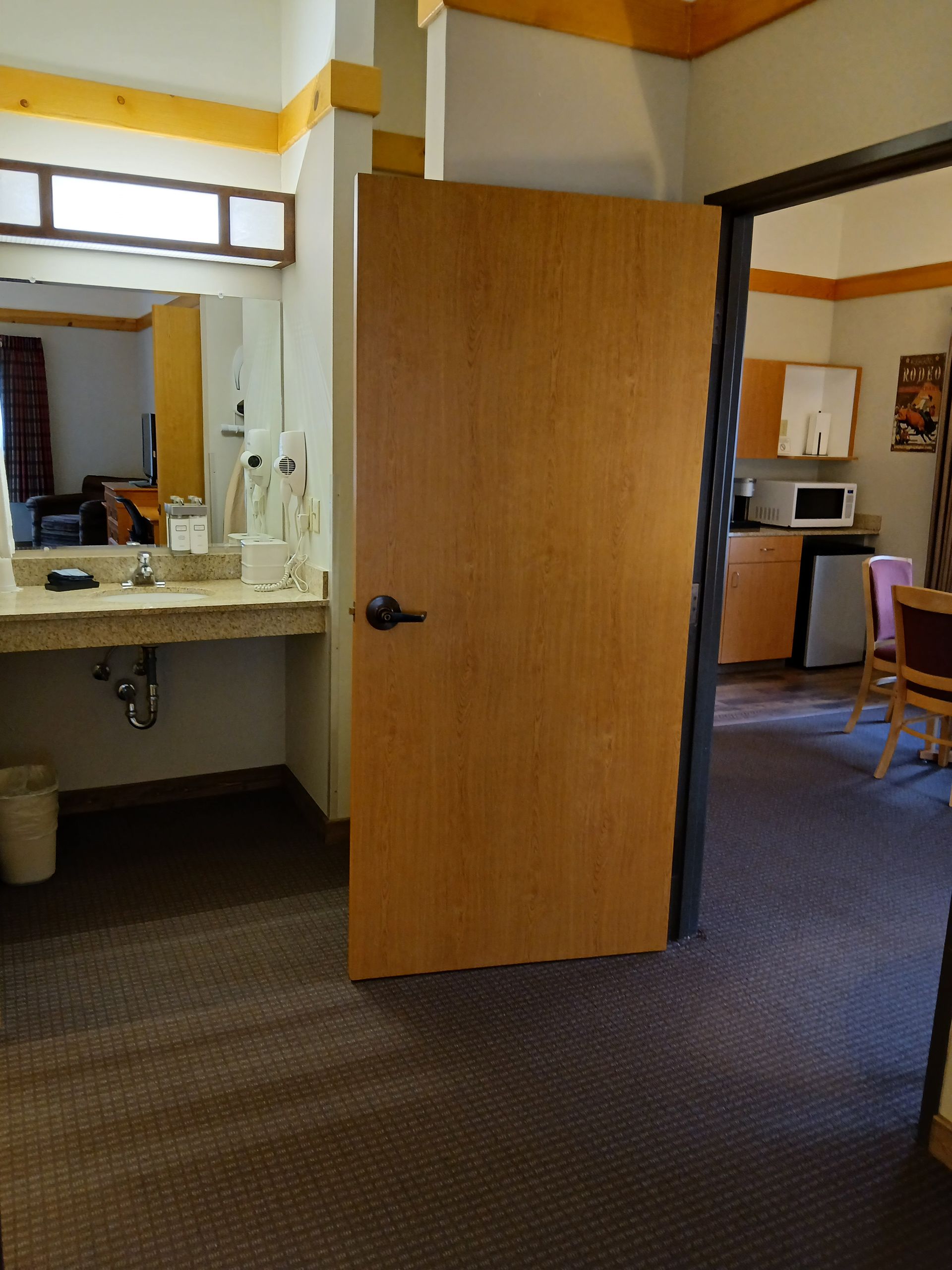 A bathroom with a sink and a door open