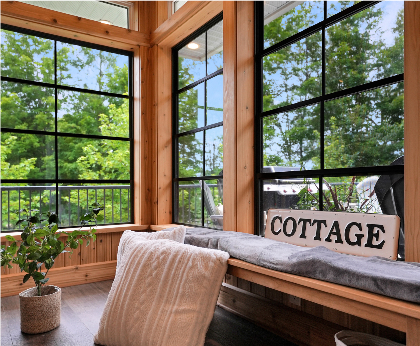 A sun room with a bench and a sign that says `` cottage ''.